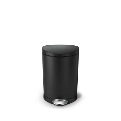 Black trash bin with a silver pedal on a white background